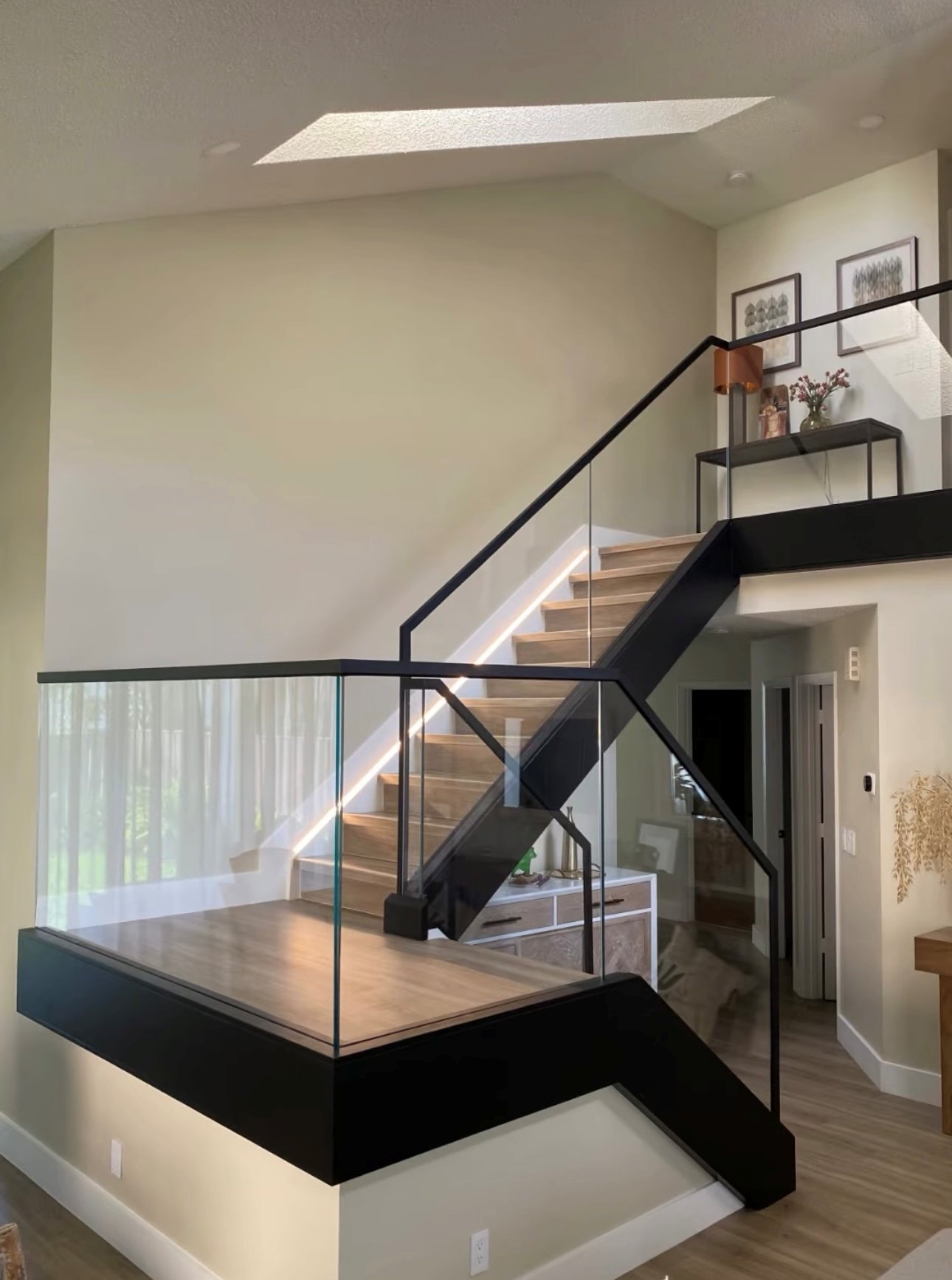 Modern glass railing system with black steel hardware